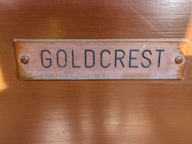 A wooden plaque with the word goldcrest attached to a wooden surface at Goldcrest in Withern near Alford