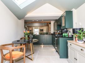 A kitchen with a table and chairs at Hilltop Cottage in Conwy