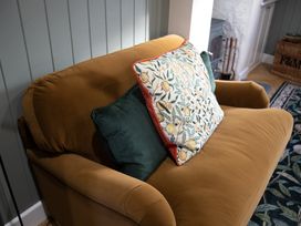 A sofa with cushions in the living room at Hilltop Cottage in Conwy