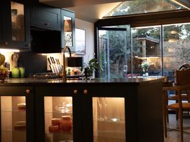 A kitchen with a counter, stove, and dining table at Hilltop Cottage in Conwy
