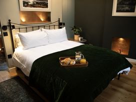 A bedroom with a bed and breakfast tray at Hilltop Cottage in Conwy