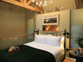 A bedroom with a bed and bedside table at Hilltop Cottage in Conwy