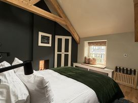 A bedroom with a bed and wardrobe at Hilltop Cottage in Conwy