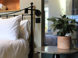 A bedroom with a bed and a plant at Hilltop Cottage in Conwy