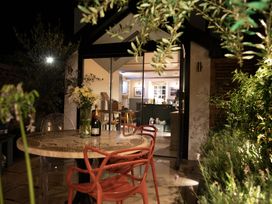 A dining area visible through glass at Hilltop Cottage in Conwy