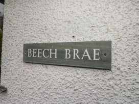 A sign reading BEECH BRAE on a wall at Beech Brae in Kendal