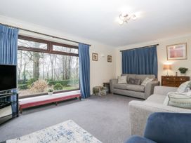 A living room with a sofa and television at Beech Brae in Kendal