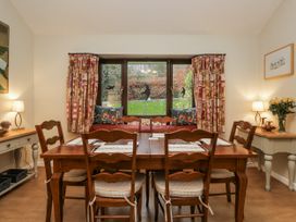 A dining room with a table and chairs at Beech Brae in Kendal