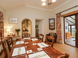 A dining room with a wooden table and chairs at Beech Brae in Kendal