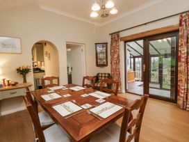 A dining room with a table and chairs at Beech Brae in Kendal