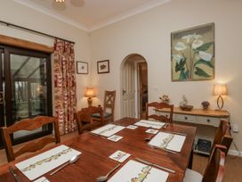 A dining room with a table and chairs at Beech Brae Kendal