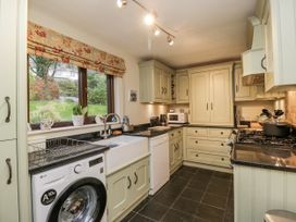 A kitchen with appliances and cabinets at Beech Brae in Kendal