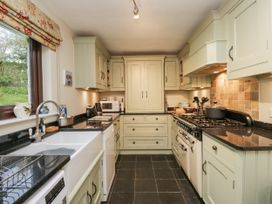 A kitchen with cabinets and appliances at Beech Brae in Kendal