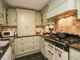 A kitchen with cabinets and stove at Beech Brae in Kendal