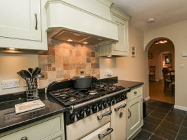 A kitchen with a stove and cooking pot at Beech Brae Kendal