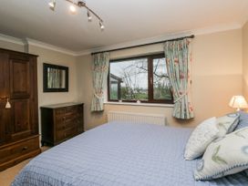 A bedroom with a bed and a window at Beech Brae in Kendal