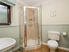A bathroom with a shower, toilet, and sink at Beech Brae in Kendal