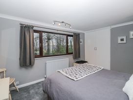 A bedroom with a bed and window at Beech Brae in Kendal