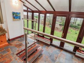 A conservatory with windows and steps at Beech Brae in Levens