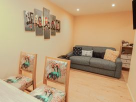A living room with a sofa and dining table at The Nook 