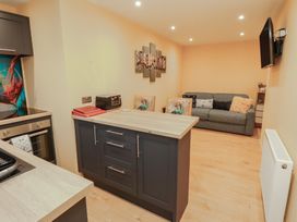 A kitchen with island and sofa at The Nook in 