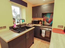 A kitchen with cabinets and appliances at The Nook in 
