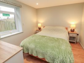 A bedroom with a bed and nightstands at The Nook 
