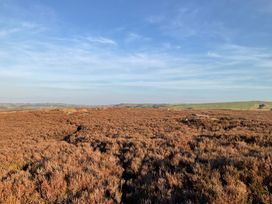 An outdoor landscape with brown vegetation under a blue sky at Little Acre in Oxenhope