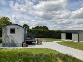 An outdoor area with a shed and deck at Little Acre in Oxenhope
