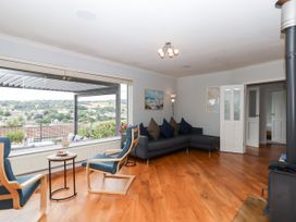 A living room with a sofa and armchairs at 15 Summerland Avenue Dawlish