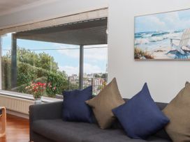 A living room with a view and cushions on a couch at 15 Summerland Avenue Dawlish
