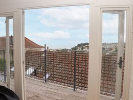 A view from a balcony showing rooftops and the sky at 15 Summerland Avenue Dawlish