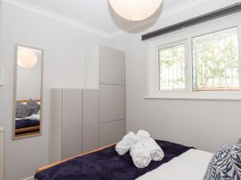 A bedroom with a bed and cabinet at 15 Summerland Avenue Dawlish