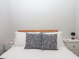 A bedroom with a bed and nightstand at 15 Summerland Avenue Dawlish