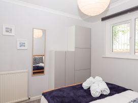 A bedroom with a bed and wardrobe at 15 Summerland Avenue Dawlish
