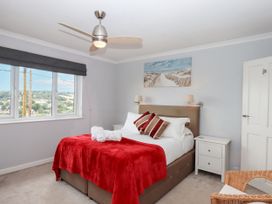 A bedroom with a bed and a bedside table at 15 Summerland Avenue in Dawlish