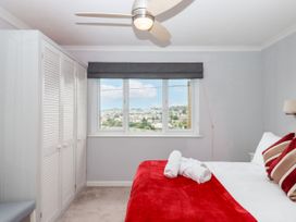 A bedroom with a bed and wardrobe at 15 Summerland Avenue in Dawlish