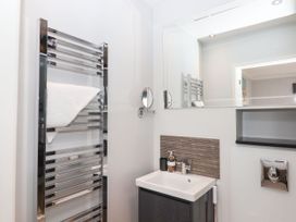 A bathroom featuring a heated towel rail and a sink at 15 Summerland Avenue Dawlish