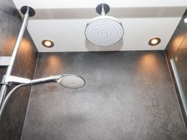 A shower area with showerhead and lighting at 15 Summerland Avenue Dawlish