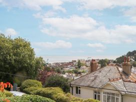 A view of the sea and houses from a hillside at 15 Summerland Avenue Dawlish
