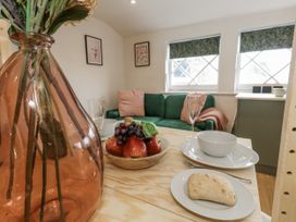 A living room with a fruit bowl and vase at Sea Pink Studio Swanage