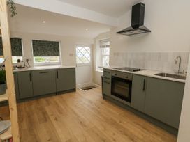 A kitchen with oven and sink at Sea Pink Studio in Swanage