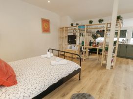 A studio with a bed and dining area at Sea Pink Studio in Swanage