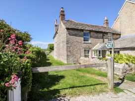 A house with flowers and a pathway at Sea Pink Studio in Swanage