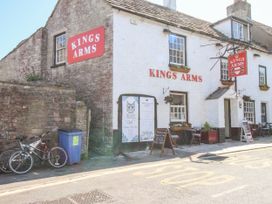 An outdoor view of the Kings Arms pub with bicycles and a menu board located at Sea Pink Studio in Swanage