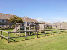 A playground with climbing frame and slide at Sea Pink Studio in Swanage