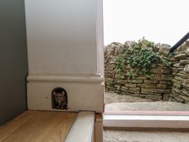 A doorway with a mouse figure near the floor at Sea Pink Studio in Swanage