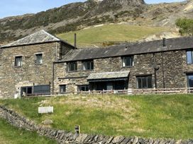 A building with stone walls and windows at Swirral Edge Cottage Glenridding