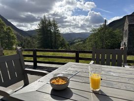 A bowl with cereal and a glass of juice on a table at Swirral Edge Cottage in Glenridding
