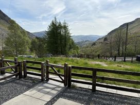 An outdoor area with a fence and pathway at Swirral Edge Cottage in Glenridding